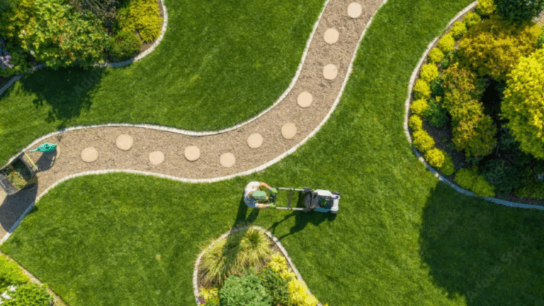 Paysagiste tondant une pelouse dans un jardin, illustrant la gestion optimisée des déplacements et du temps de travail grâce à la solution Geopro d’Océan.