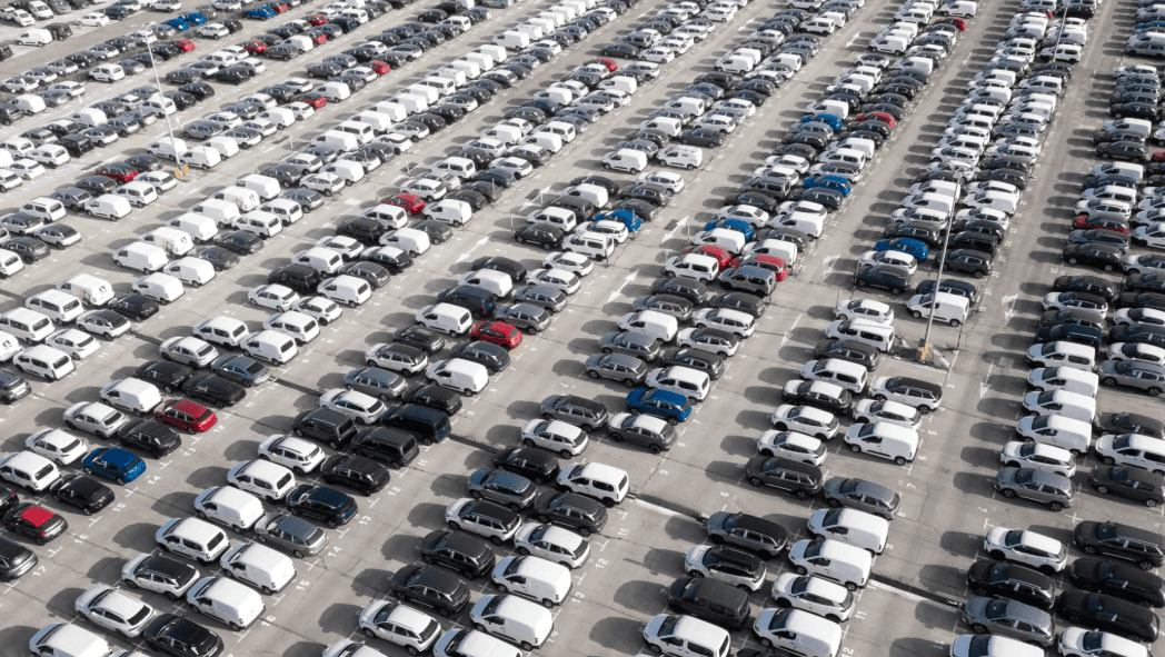 taux-utilisation-disponibilite-flotte-entreprise-gestion-vehicules-ocean.png (3) Vue aérienne d’un grand parking de véhicules d’entreprise illustrant la gestion et le suivi du taux d’utilisation d’une flotte automobile.